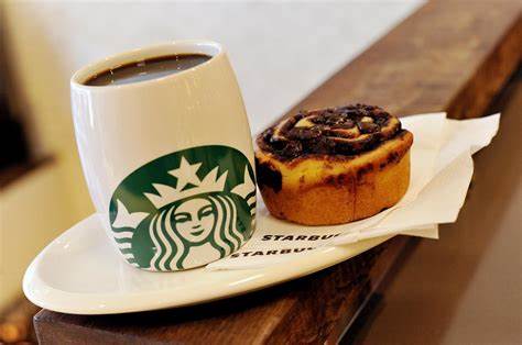 Cup of coffee and cinnamon roll at Starbucks